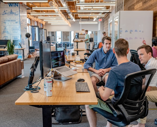 Diverse hiring team reviewing candidates together around a table in a modern office
